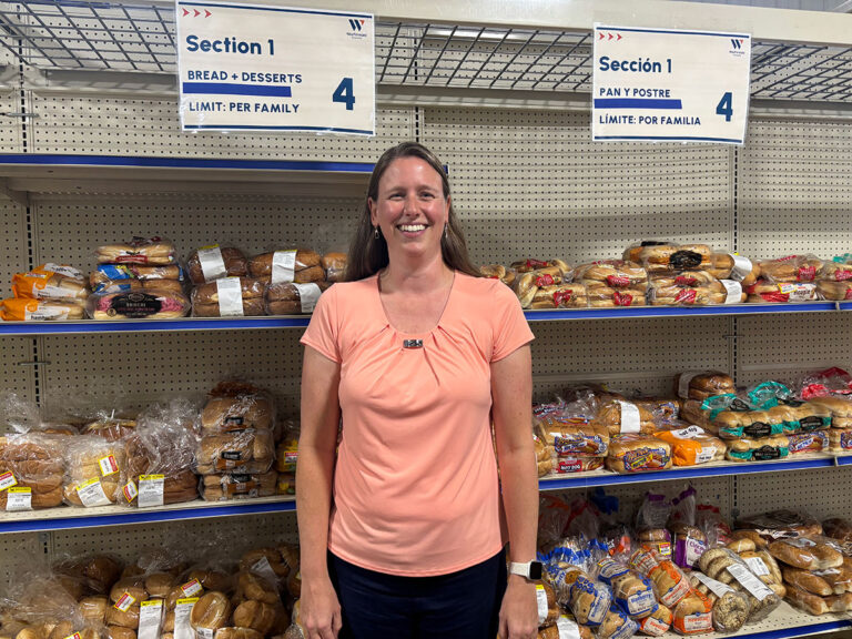 Jen Wagner smiling standing in front of pantry shelf with bread.